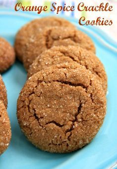 some cookies are on a blue plate with the words orange spice crockle cookies