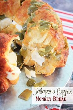 a close up of a plate of food with bread and vegetables on it that says jalapeno popper monkey bread