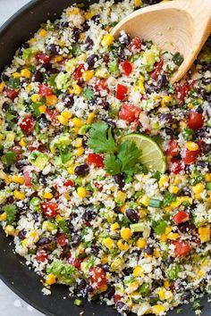 mexican rice salad with black beans, corn and cilantro in a skillet