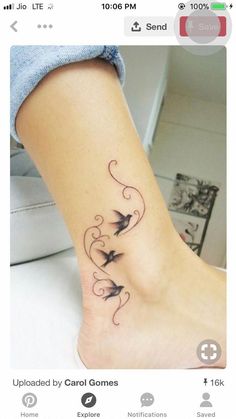 a tattoo on the foot of a woman with birds flying around her ankles and swirls coming out of it