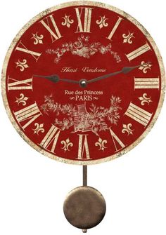 a red and gold clock with roman numerals on the face that says rue des princess paris