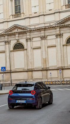 a blue car is driving down the street