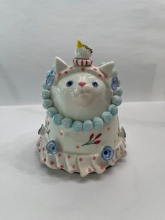 a ceramic cat figurine sitting on top of a table