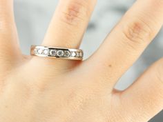 a woman's hand with a diamond ring on it