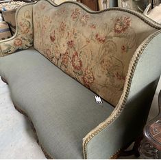 an old couch is upholstered with fabric