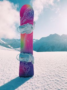 a snowboard is standing upright in the snow