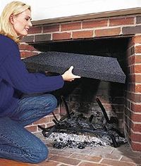 a woman kneeling down next to a fire place