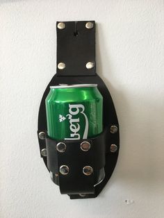 a soda can holder hanging on the wall