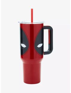 a red and black cup with a deadpool face on it, next to a straw