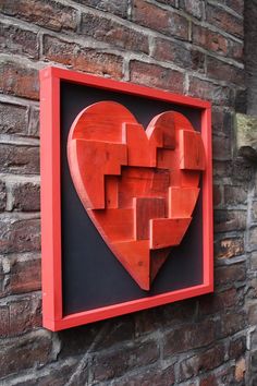 a red heart is mounted on a brick wall