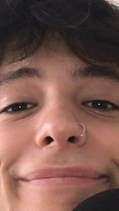 a close up of a person with a nose ring