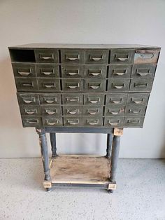 an old metal filing cabinet with many drawers on the bottom and one drawer below it