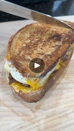 a grilled cheese and egg sandwich on a cutting board