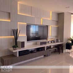 a large flat screen tv mounted to the side of a wall in a living room