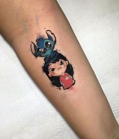 a woman's leg with a tattoo on it and an image of a cartoon character