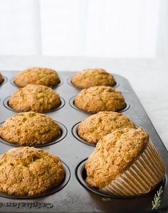 freshly baked muffins sitting in a muffin tin ready to be eaten on the counter