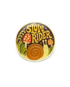 a pin with the words slow rider on it and a snail crawling in front of it