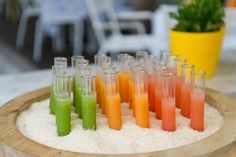 there are many different colored liquids in test tubes on top of white rice and sand