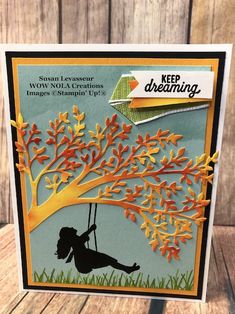 a handmade card with a girl swinging on a tree and the words keep dreaming