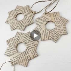 an ornament made out of old book pages is hanging from twine string