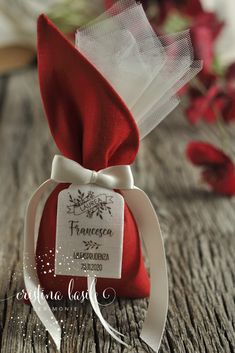 a red and white ribbon tied to a bottle with a label on it that says frances