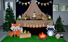 an outdoor birthday party with woodland animals and decorations