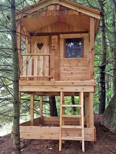 a wooden tree house in the woods