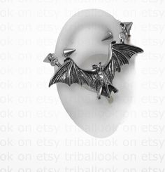 a pair of earrings with bats on them