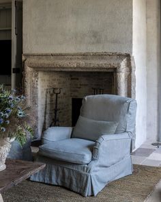 a chair sitting in front of a fire place