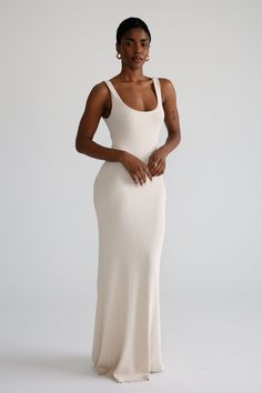 Indulge in the comfort and style of this elegant knit maxi dress. Crafted from premium quality yarns, it features a scoop neckline that adds a touch of sophistication to your wardrobe. Made from a heavy-weight stretchy fabrication, this modest design flatters the figure in an alluring way. Cream Maxi Dress Outfit, Elegant Stretch Knit Maxi Dress, Chic Fitted Maxi Dress With Scoop Neck, Chic Fitted Scoop Neck Maxi Dress, Chic Solid Color Ribbed Maxi Dress, Fitted Scoop Neck Chic Maxi Dress, Elegant Seamless Maxi Dress, Elegant Knit Maxi Dress, Beige Maxi Dress With Fitted Straight Neckline