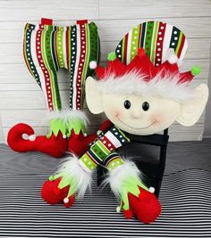 a stuffed toy elf sitting on top of a chair