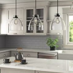 a kitchen with gray cabinets and white counter tops