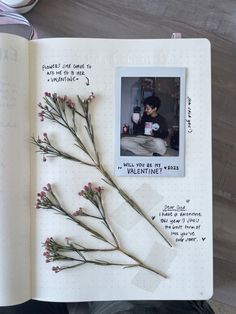 an open notebook with flowers and writing on it