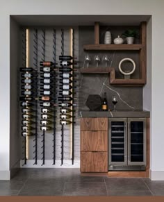 a wine rack with bottles and glasses on it in a room that has tile flooring