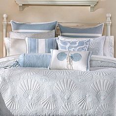 a bed with blue and white comforters in a bedroom