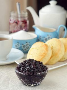 blueberry compote with biscuits and tea on table