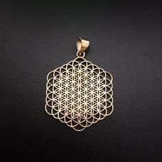 a gold pendant on a black background