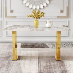 a white table with gold legs and a mirror on the wall in front of it