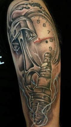 a man with a tattoo on his arm has a speedometer and wrench in it