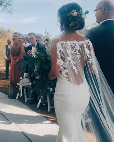 a bride and groom walking down the aisle