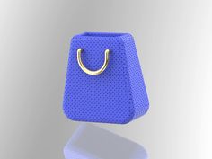 a blue purse with a gold handle hanging from it's side on a reflective surface