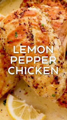 lemon pepper chicken on a plate with sliced lemons