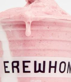 a close up of a pink drink in a plastic cup