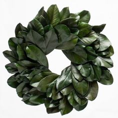 a wreath made out of green leaves on a white background