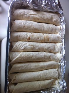 several uncooked tortillas wrapped in aluminum foil