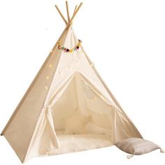 a teepee with lights on it and a pillow in the corner next to it