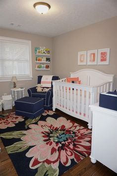 a baby's room with a crib, chair, and rug on the floor