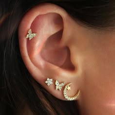 an ear with three stars and a moon on it