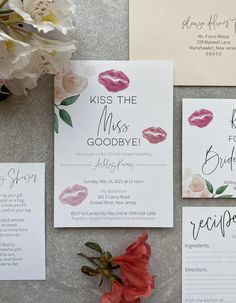 the wedding stationery is laid out on top of each other, with flowers and calligraphy