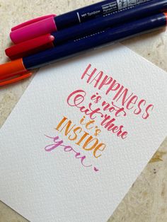 two markers and some writing on a piece of paper with the words happiness is what we use to inspire